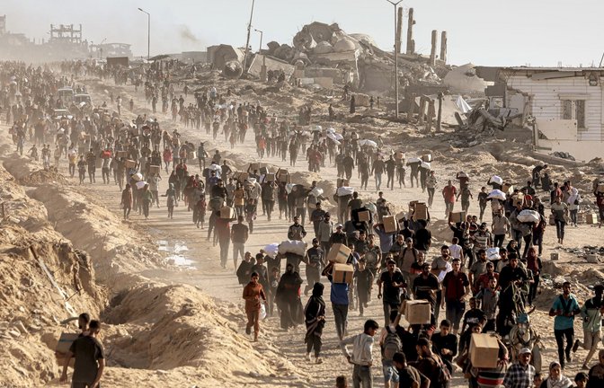 Palästinenser tragen Lebensmittel, die von der Gaza Humanitarian Foundation verteilt wurden.<span class='image-autor'>Foto: Omar Ashtawy/APA  via ZUMA</span>