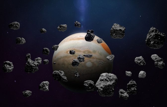 Asteroidenschwarm mit dem Jupiter im Hintergrund.<span class='image-autor'>Foto: Imago/Pond5 Images</span>