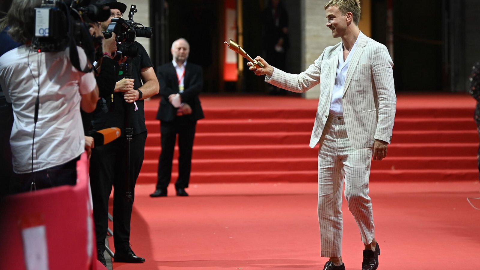 Bei den Herren trauen sich nur wenige:  Schauspieler Albrecht Schuch kommt im sommerlich hellen Anzug.Foto: dpa/Jens Kalaene