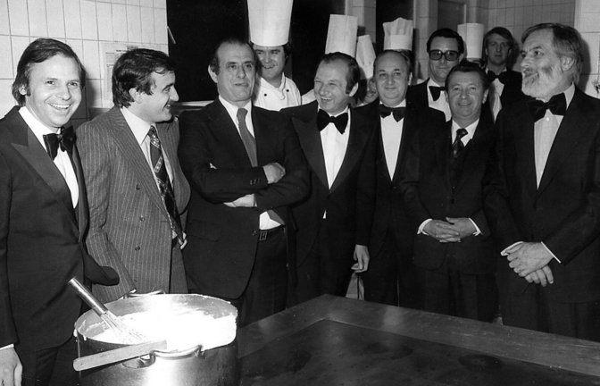 Die kulinarische Prominenz bei der Eröffnung der Schwarzwaldstube 1977. Erste Reihe von links nach rechts: Eckart Witzigmann, Franz Keller jr., Paul Bocuse †, Willi Finkbeiner †, Paul Haeberlin †, François Bise †, Jean Troisgros †. Zweite Reihe von links nach rechts: Wolfgang Staudenmaier (1. Küchenchef der Schwarzwaldstube), Erdmann Degler † (damals Direktor der TT), Heiner Finkbeiner. † = verstorben Foto: Traube Tonbach<span class='image-autor'>Foto: Archiv Traube Tonbach</span>