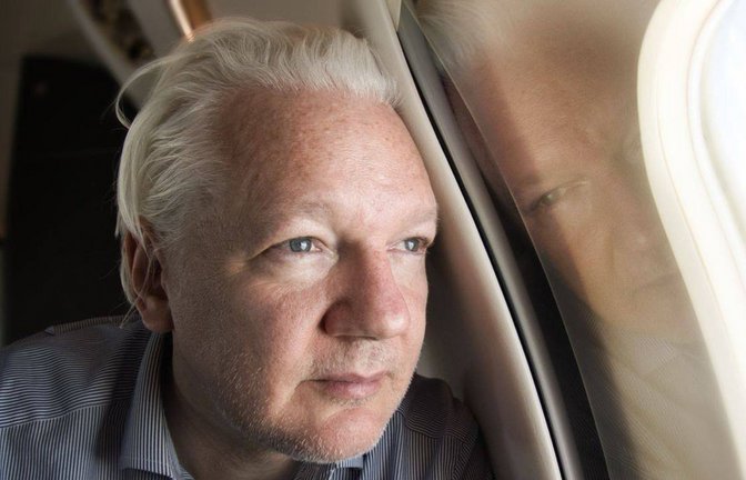 Julian Assange blickt aus dem Fenster des Flugzeuges, das auf dem Weg zum Gerichtsverfahren in Bangkok Zwischenhalt machen wird.<span class='image-autor'>Foto: IMAGO/AAP/IMAGO/SUPPLIED BY WIKILEAKS</span>