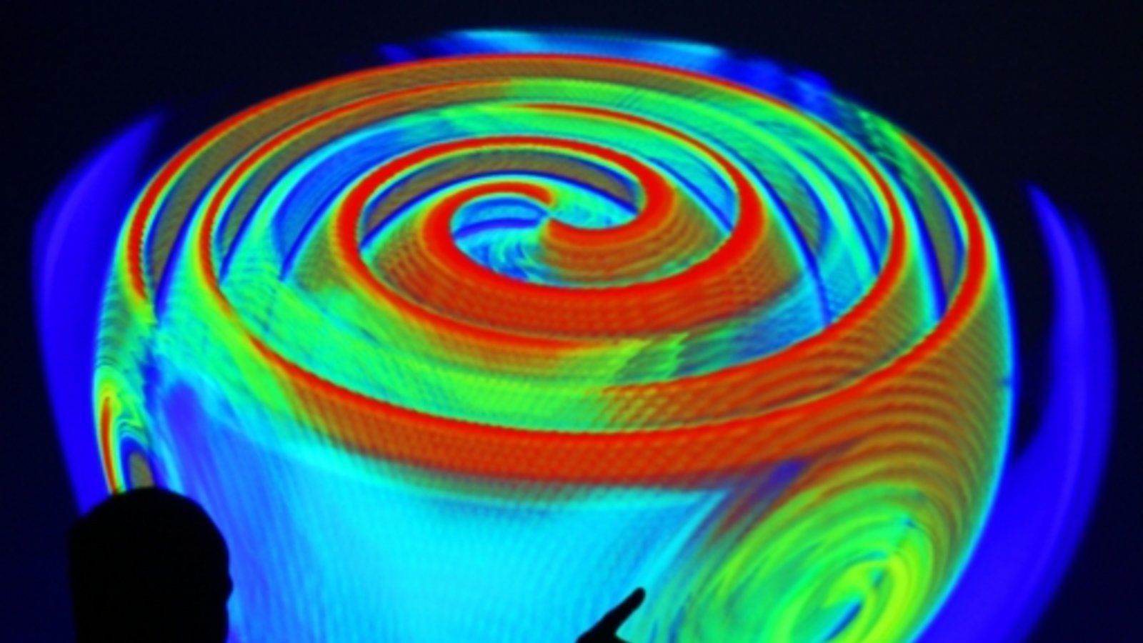 Ein Mitarbeiter des Max-Planck-Instituts für Gravitationsphysik in Potsdam erläutert anhand einer Projektion einer Computersimulation die Ausbreitung von Gravitationswellen.Foto: dpa Ein Mitarbeiter des Max-Planck-Instituts für Gravitationsphysik in Potsdam erläutert anhand einer Projektion einer Computersimulation die Ausbreitung von Gravitationswellen.Foto: dpa
