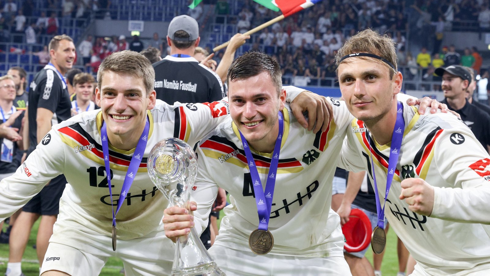 Drei strahlende Weltmeister mit dem WM-Pokal: Jakob Kilpper (von links), Johannes und Jaro Jungclaussen. Foto: Spille/Faustball Deutschland