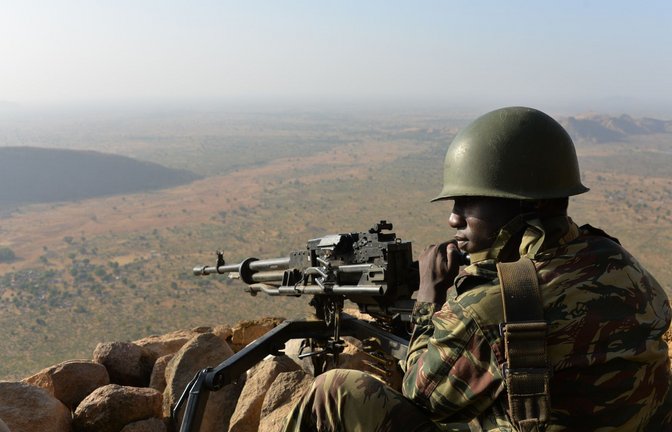 Ein Soldat der nigerianischen Armee an einem Maschinengewehr. Seit dem Jahr 2009 sind in dem afrikanischen Land zehntausende Menschen getötet worden (Archivbild).<span class='image-autor'>Foto: AFP/Reinnier KAZE</span>