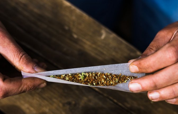 Ein Mann beim Drehen einer Cannabis-Zigarette<span class='image-autor'>Foto: Philipp von Ditfurth/dpa</span>