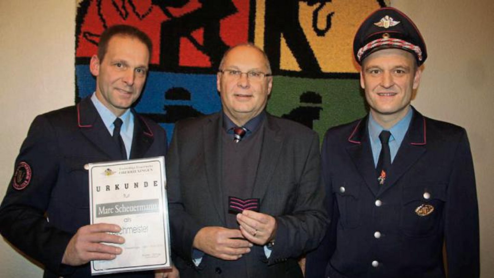 Kommandant Martin Schray (links) und Bürgermeister Werner Somlai befördern Marc Scheuermann zum Löschmeister. Foto: Jähne Kommandant Martin Schray (links) und Bürgermeister Werner Somlai befördern Marc Scheuermann zum Löschmeister. Foto: Jähne