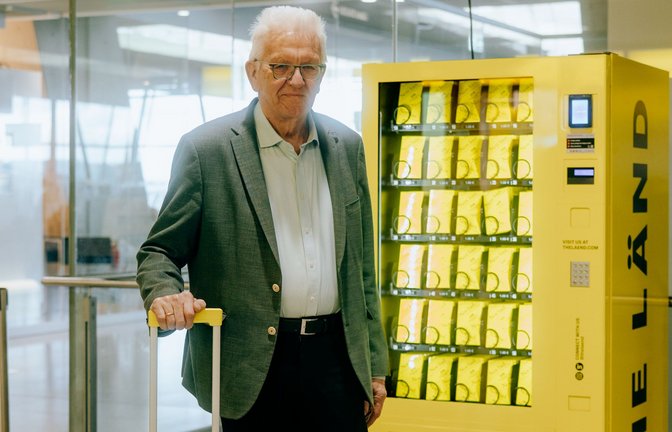 Ministerpräsident Winfried  Kretschmann vor dem „Nett-hier“-Sticker-Automat am Flughafen.<span class='image-autor'>Foto: lkay Karakurt/Staatsministerium BW</span>