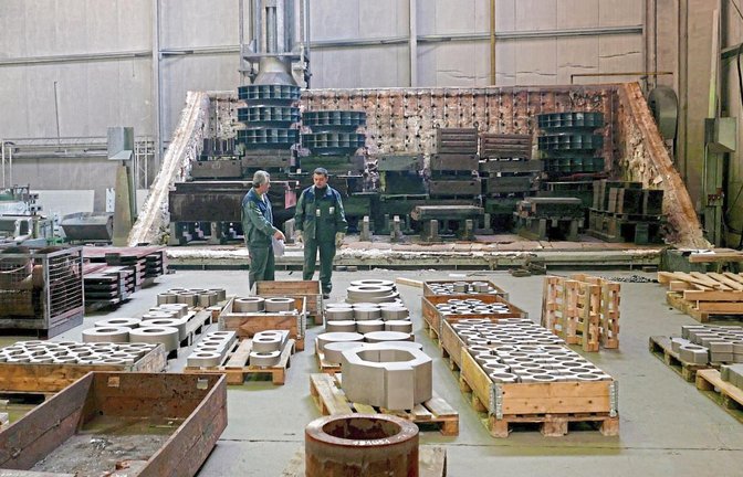 Im Hintergrund sieht man die untere Hälfte eines Glühofens. Durch Erwärmen und Abkühlen können die mechanischen Eigenschaften des Metalls oder der Metalllegierungen verändert werden.
