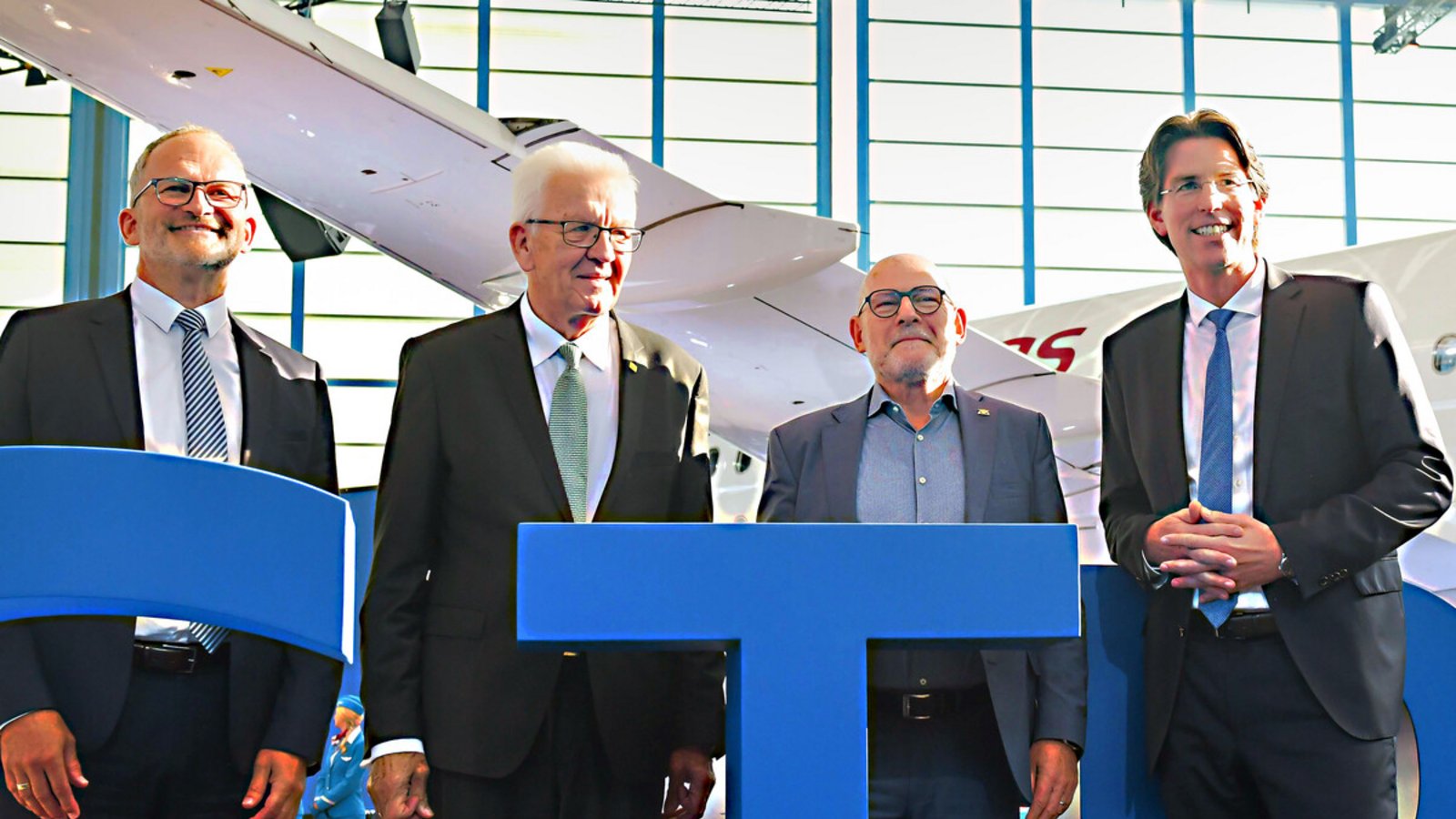 Feiern unterm Flügel: Ministerpräsident Winfried Kretschmann (2.v.l.), Verkehrsminister Winfried Hermann (2.v.r.) und die Flughafengeschäftsführer Carsten Poralla (links) und Ulrich Heppe.Foto: Lichtgut//Kovalenko Feiern unterm Flügel: Ministerpräsident Winfried Kretschmann (2.v.l.), Verkehrsminister Winfried Hermann (2.v.r.) und die Flughafengeschäftsführer Carsten Poralla (links) und Ulrich Heppe.Foto: Lichtgut//Kovalenko