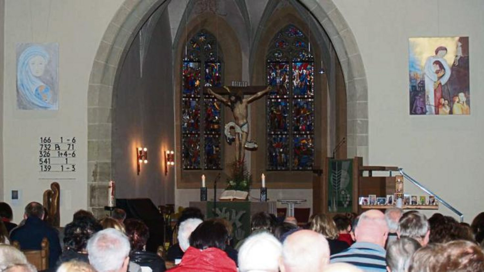 Noch wirken sie fremd, doch bald werden dem Kirchenbesucher die Bilder von Shirley Grözinger-Hoffmann (links) und Traute Leinen (über der Kanzel) ein vertrauter und – so hoffen die Künstlerinnen – auch ein Trost spendender Anblick sein.  Foto: Filitz