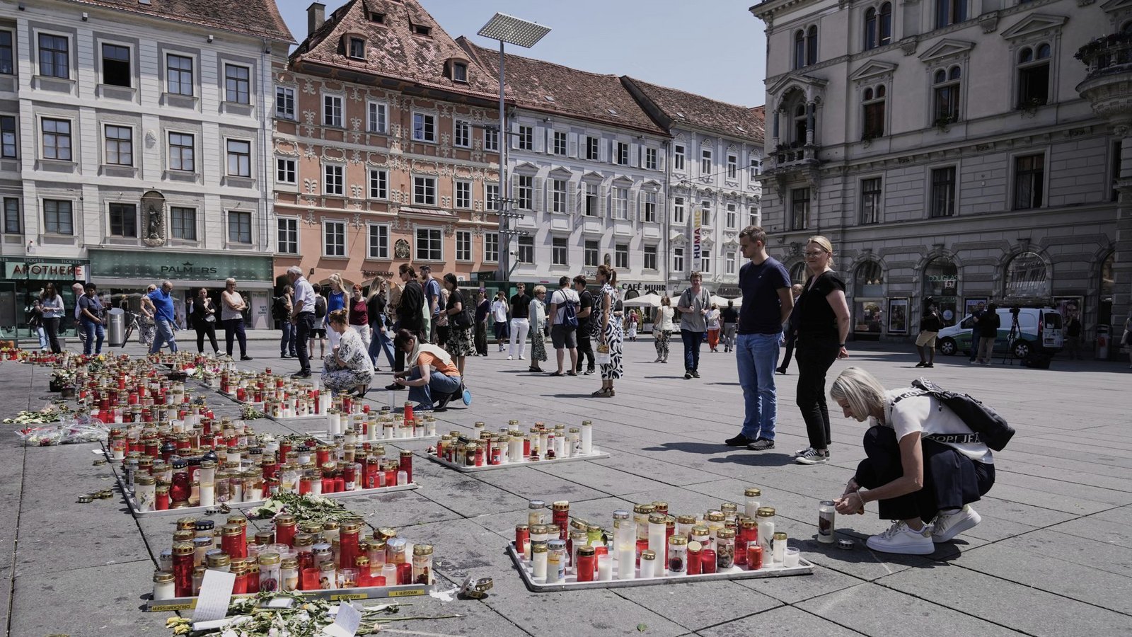Menschen legten nach dem Amoklauf in Graz Blumen nieder.Foto: Darko Bandic/AP/dpa/Darko Bandic