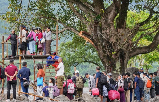 Menschen im Katastrophengebiet in Nepal warten darauf, in eine provisorische Seilbahn besteigen zu können.<span class='image-autor'>Rajesh Kumar Singh/AP/dpa</span>