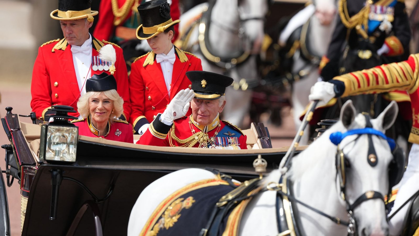 In einer offenen Kutsche fährt das britische Königspaar durch London.Foto: Kirsty Wigglesworth/AP/dpa