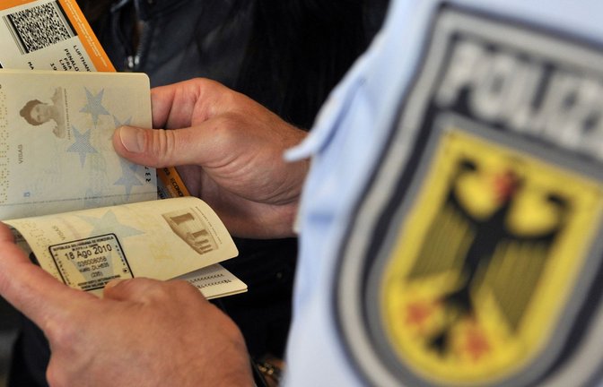 Ein Bundespolizist überprüft auf dem Frankfurter Flughafen den Ausweis eines Fluggastes.<span class='image-autor'>Foto: dpa/Marius Becker</span>