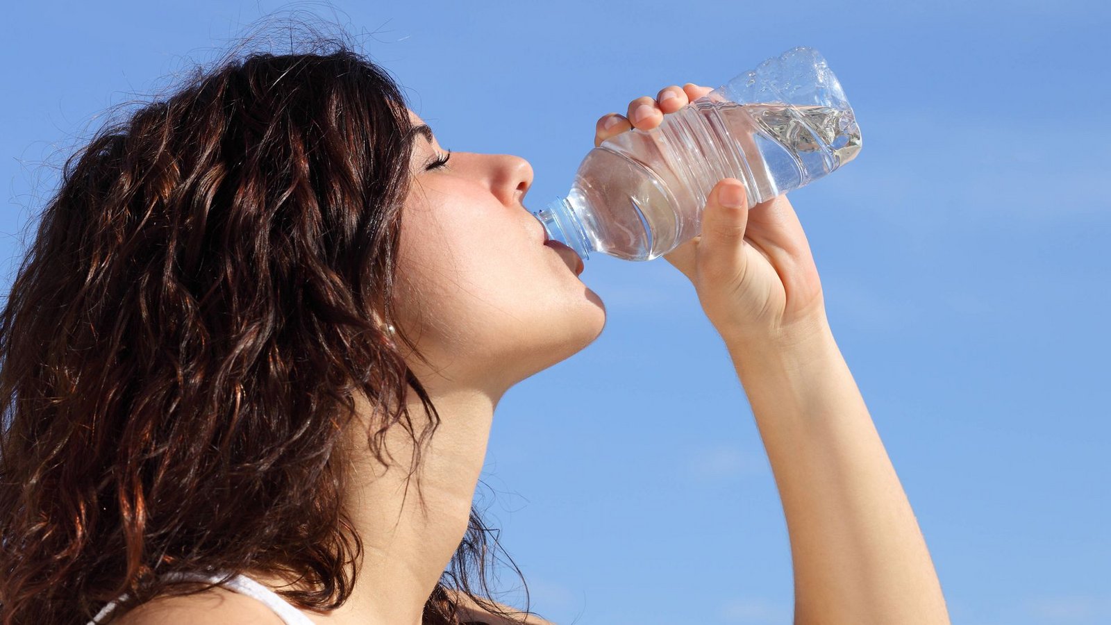 Profil einer Frau, die Wasser aus einer Plastikflasche trinkt. Im Hintergrund ist ein blauer Himmel zu sehen (Symbolfoto).Foto: IMAGO/Design Pics/IMAGO Profil einer Frau, die Wasser aus einer Plastikflasche trinkt. Im Hintergrund ist ein blauer Himmel zu sehen (Symbolfoto).Foto: IMAGO/Design Pics/IMAGO