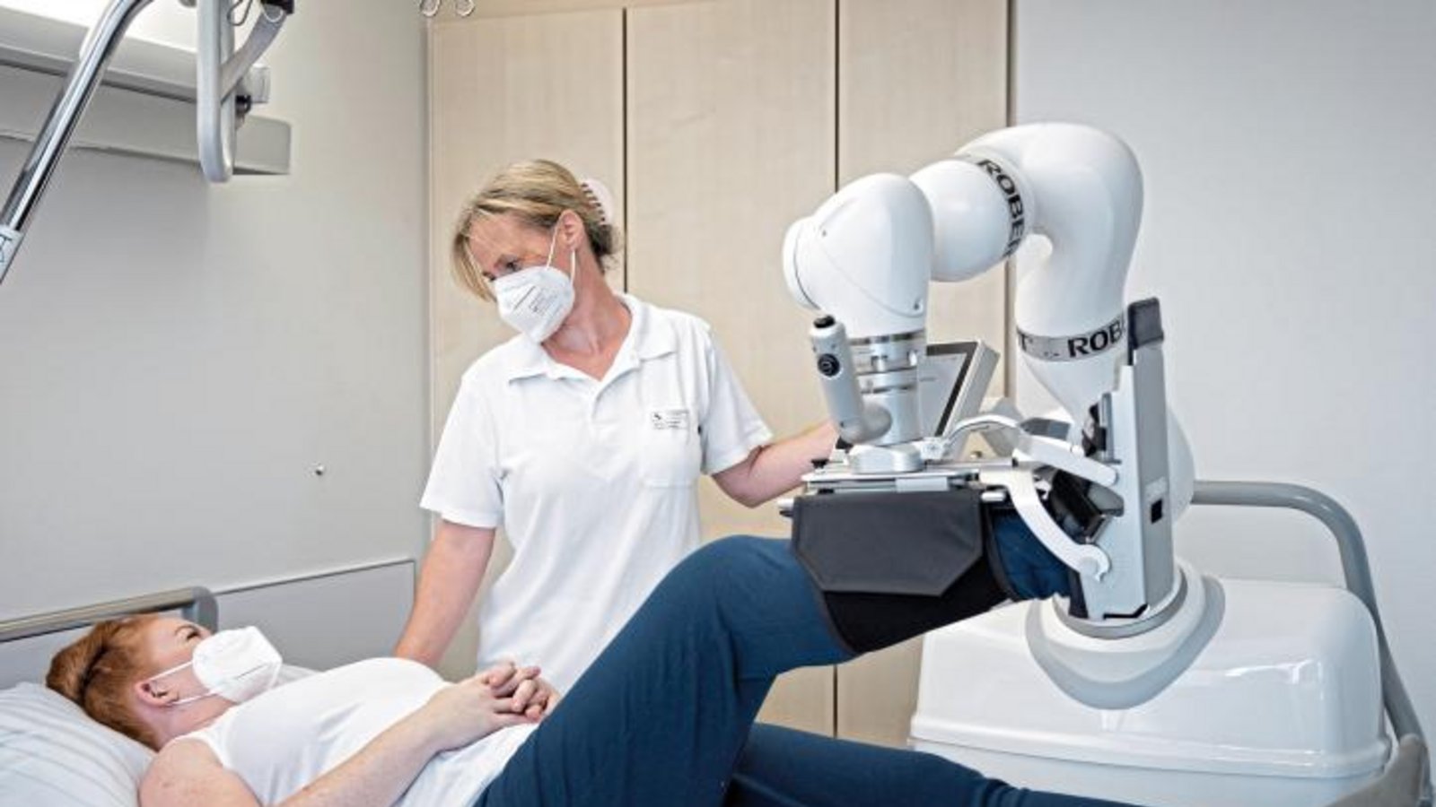 Physiotherapeutin Melanie kümmert sich mit Unterstützung von Roboter-Therapeut Robert um eine Patientin. Foto: RKH Physiotherapeutin Melanie kümmert sich mit Unterstützung von Roboter-Therapeut Robert um eine Patientin. Foto: RKH