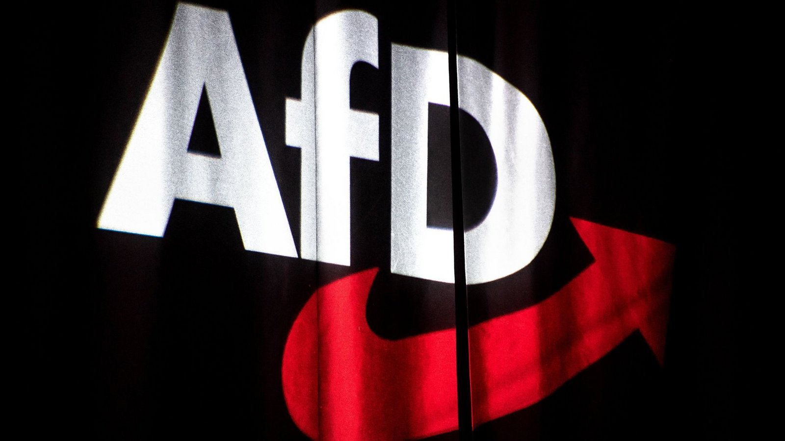 Das Logo der AfD auf einen Vorhang projeziert – Politiker von SPD und Union warnen vor einer Stimmabgabe für die AfD (Symbolfoto).Foto: dpa/Sina Schuldt