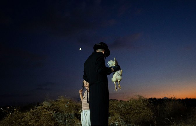 Ein orthodox-jüdischer Mann begeht im israelischen Beit Schemesch das Kapparot-Ritual. Am Vorabend von Jom Kippur wird als Symbol der Sühne ein lebendes Huhn über dem Kopf einer Person geschwenkt und dann geschlachtet.<span class='image-autor'>Foto: Oded Balilty/AP/dpa</span>