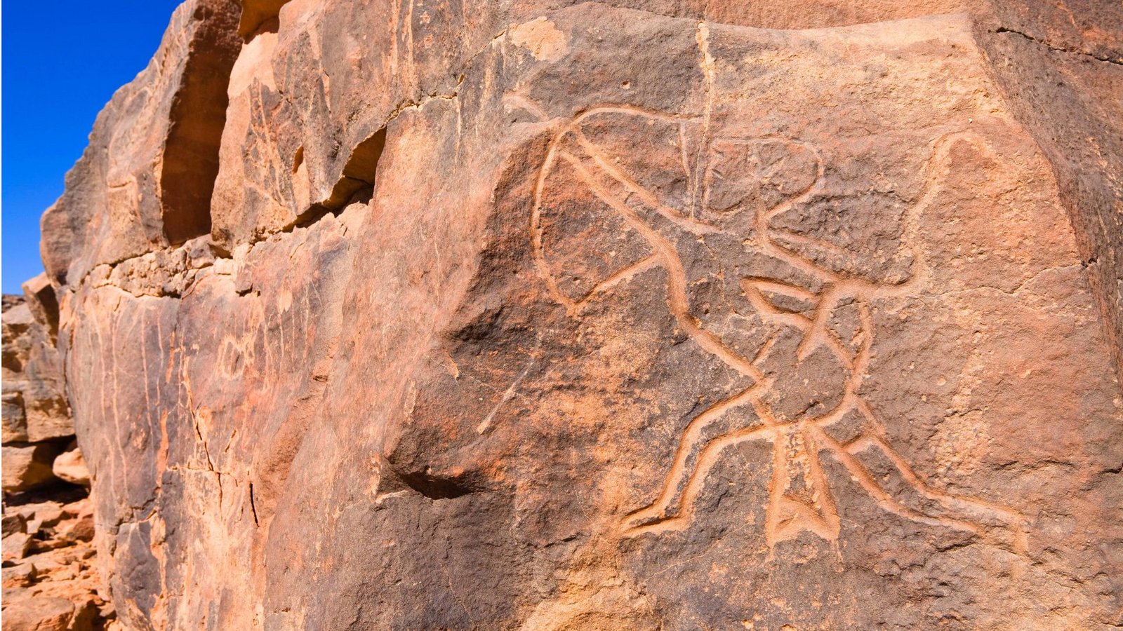 Felsgravur eines steinzeitlichen Jägers mit Pfeil und Bogen in der Steinwüste des Wadi Mathendous in LibyenFoto: Imago/Blickwinkel Felsgravur eines steinzeitlichen Jägers mit Pfeil und Bogen in der Steinwüste des Wadi Mathendous in LibyenFoto: Imago/Blickwinkel