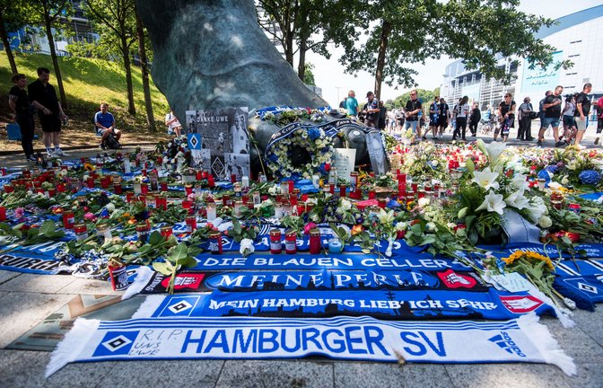 Zahlreiche Blumen, Kerzen und Schals vor dem Seeler-Bronzefuß am Hamburger Volksparkstadion.<span class='image-autor'>Foto: dpa/Daniel Bockwoldt</span>