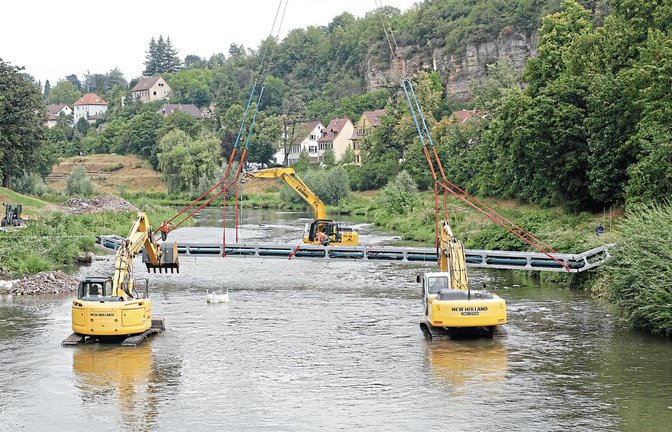 Das könnte die Premiere eines „Synchron-Baggerns“ gewesen sein: Die drei Baumaschinen transportierten die Konstruktion von der Dürrmenzer Enzseite zur anderen. Fotos: Kollros