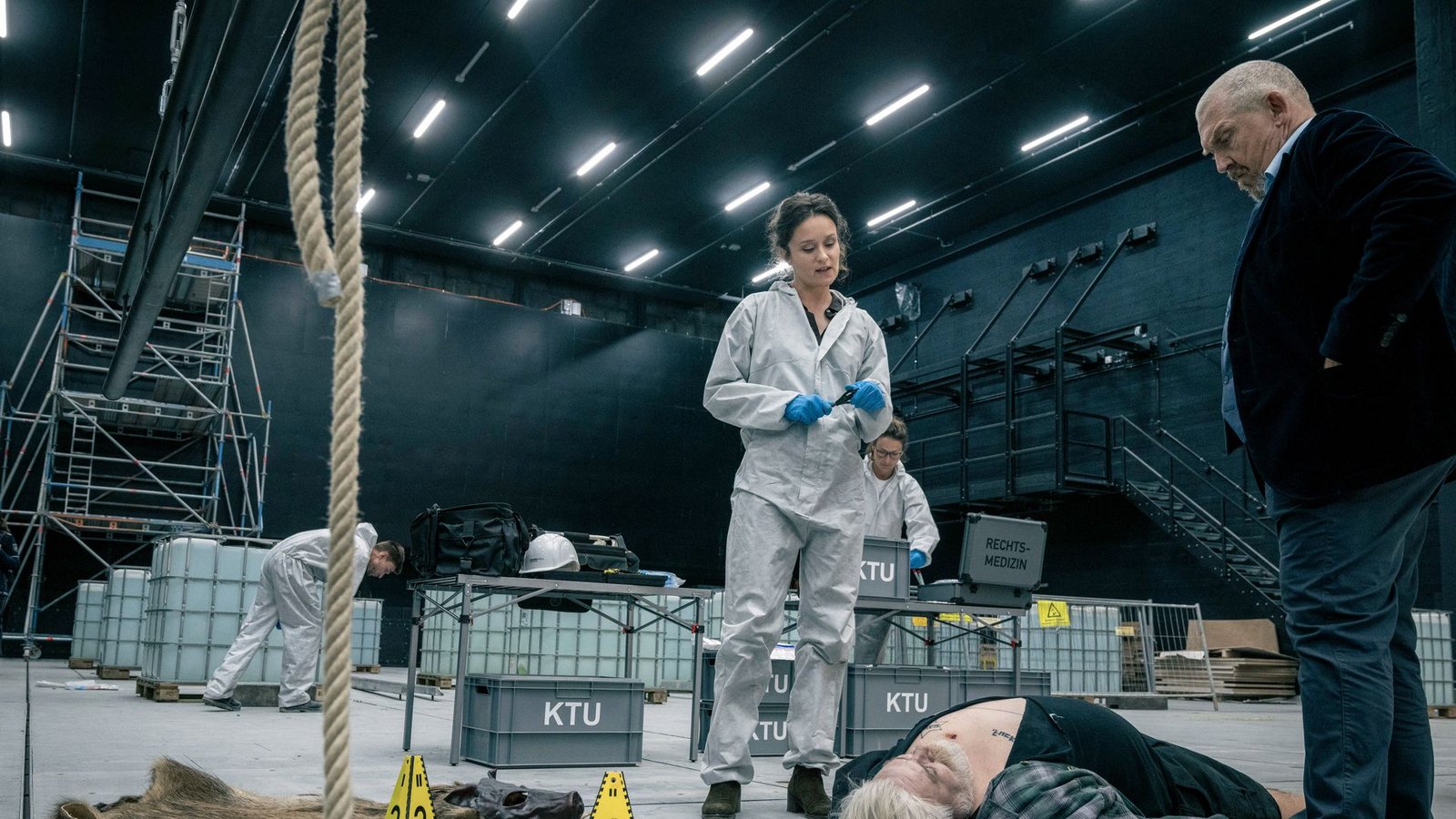 Die KTU-Leiterin Natalie Förster (Tinka Fürst) untersucht eine zweite Leiche. Auch hier ist der Fundort nicht Tatort. Bei dem Toten handelt es sich um den Opern-Schuhmacher und Death-Metal-Musiker Willi Köpke (Aljoscha Stadelmann).Foto: WDR/Thomas Kost