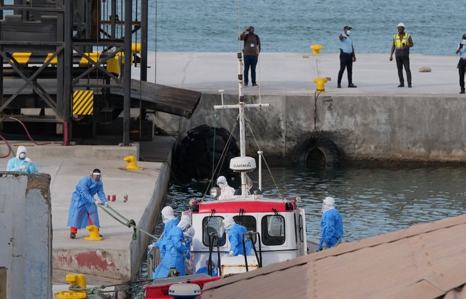 Gesundheitspersonal in Schutzkleidung evakuiert Patienten vom Kreuzfahrtschiff "Hondius" in einem Hafen.<span class='image-autor'>Foto: Misper Apawu/AP/dpa</span>