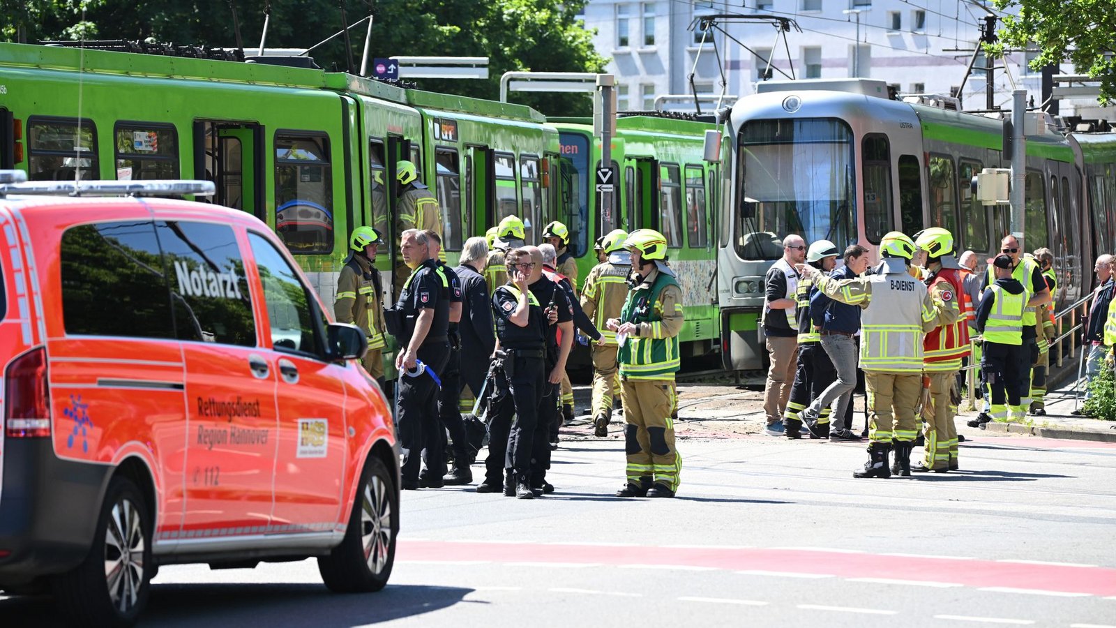 Einsatzkräfte von Polizei und Feuerwehr stehen nach einem Unfall neben zwei Stadtbahnen.Foto: Julian Stratenschulte/dpa