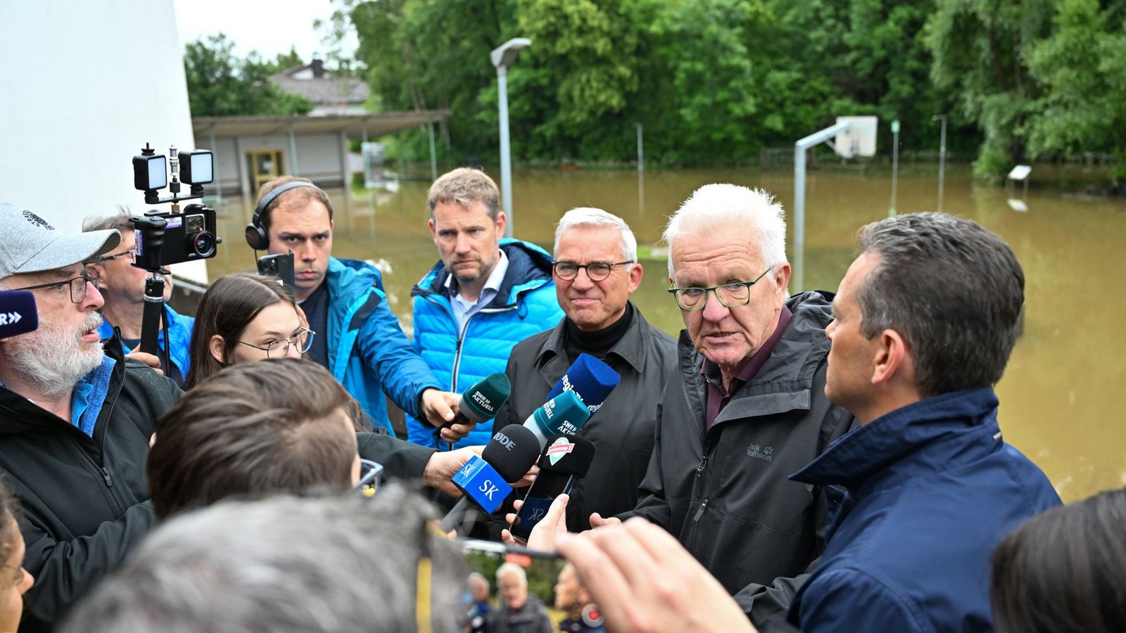 Meckenbeuren: Winfried Kretschmann (Grüne, 2.v,r), Ministerpräsident von Baden-Württemberg, und Landesinnenminister Thomas Strobl (CDU, 3.v.r.) stellen sich nach einer Besichtigung der Hochwasserschäden den Fragen der Journalisten.Foto: dpa/Felix Kästle Meckenbeuren: Winfried Kretschmann (Grüne, 2.v,r), Ministerpräsident von Baden-Württemberg, und Landesinnenminister Thomas Strobl (CDU, 3.v.r.) stellen sich nach einer Besichtigung der Hochwasserschäden den Fragen der Journalisten.Foto: dpa/Felix Kästle
