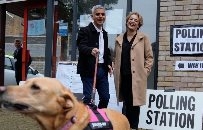 Londons Bürgermeister Sadiq Khan kommt mit seiner Frau Saadiya Ahmed und dem gemeinsamen Hund zur Stimmabgabe.<span class='image-autor'>Foto: Kin Cheung/AP</span>