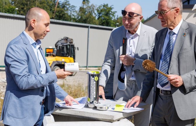 Eifrig beim Geschäft:&nbsp; Der Böblinger Oberbürgermeister Stefan Belz (links) steuert das Klopapier bei, der Landrat Roland Bernhard (rechts)&nbsp; eine goldene Klobürste&nbsp; und Frank Schuhmacher vom Restmüllheizkraftwerk (Mitte) versenkt die Utensilien in der Zeitkapsel.<span class='image-autor'>Stefanie Schlecht</span>