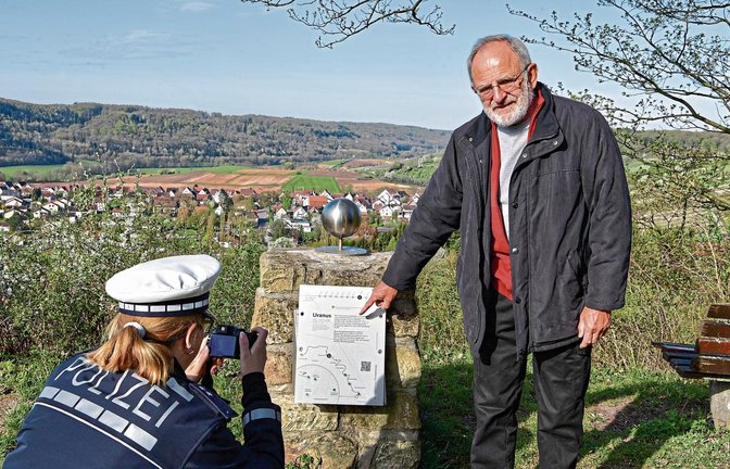 Karl-Heinz Böckle zeigt der Polizei den Schaden am Uranus-Nachbau. Es ist nicht die erste Beschädigung am Planetenweg.  Foto: Kalb