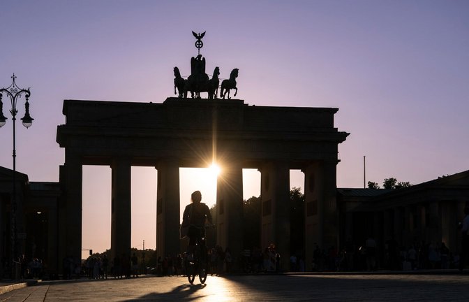 In der Hauptstadt neigt sich der Tag dem Ende zu. Im Licht der untergehenden Sonne ist die Quadriga auf dem Brandenburger Tor in Berlin nur als Silhouette zu erkennen.<span class='image-autor'>Foto: Paul Zinken/dpa</span>