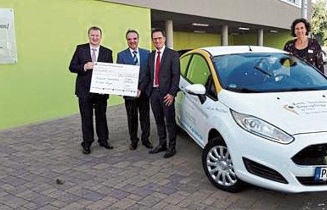 Bei der symbolischen Spendenübergabe ist das neue Auto schon vor Ort.  Foto: p