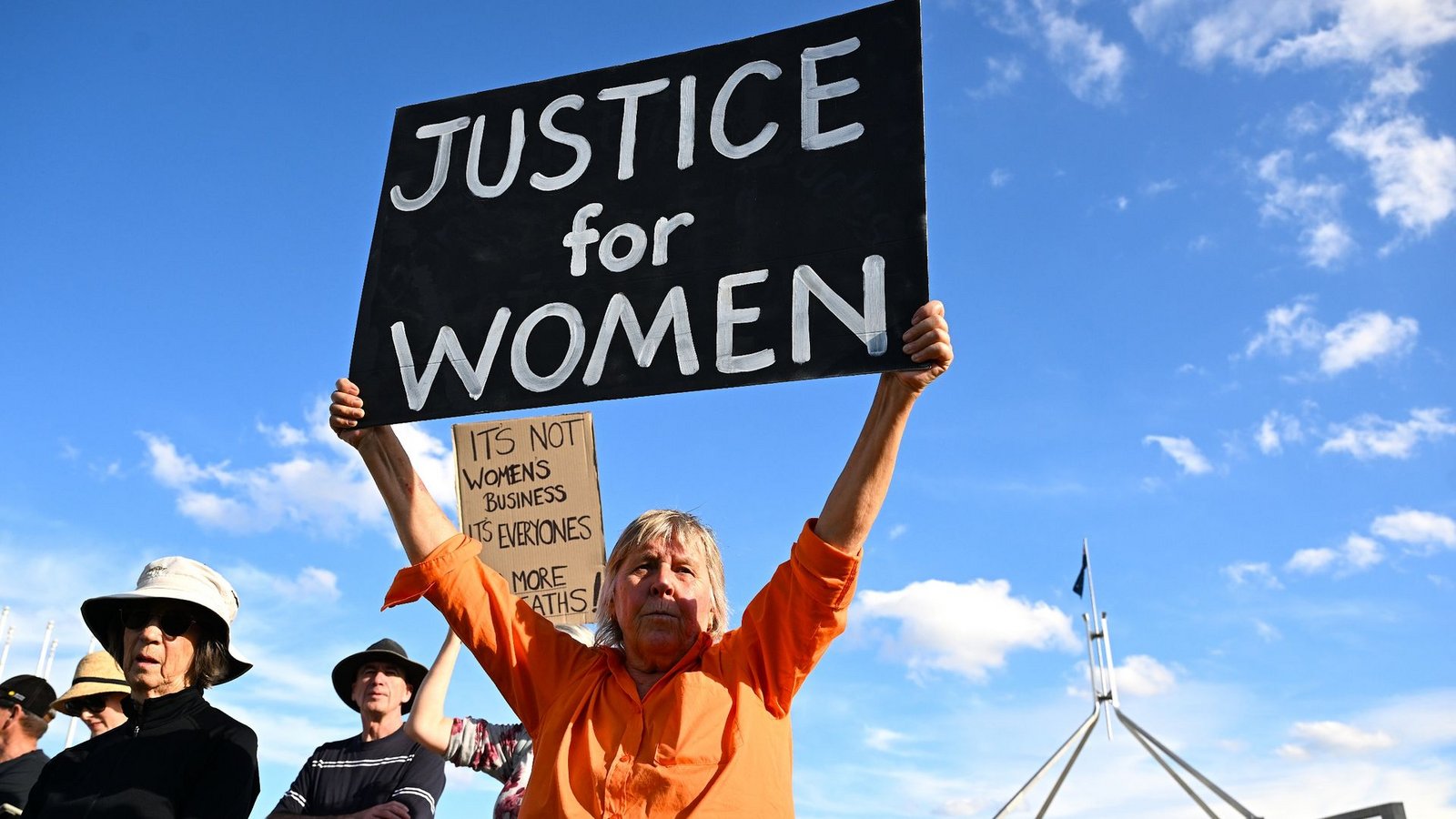 In Canberra fordert eine Frau "Justice for Women" (Gerechtigkeit für Frauen).Foto: Lukas Coch/AAP/dpa
