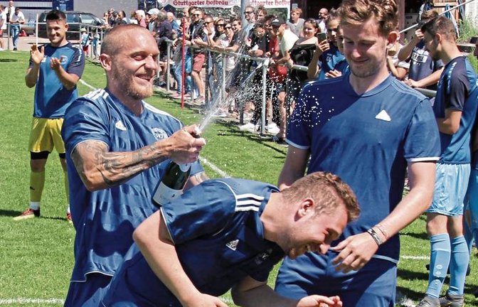 Fabian Lehmann (von links) verpasst Riccardo Solombrino nach dem Schlusspfiff bei der Partie gegen den SV Sternenfels II erst einmal eine Sektdusche. Foto: Nachreiner